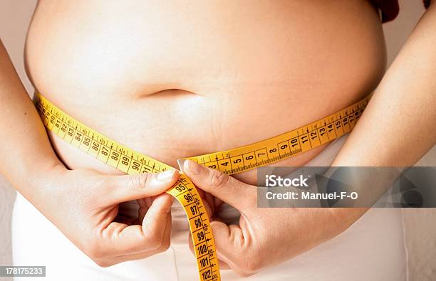 Checking Fats With A Measure Tape Stock Photo - Download Image Now - Overweight, Teenager, Abdomen