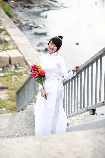 Vietnamese young girl in white traditional dress aodai (Ao Dai)