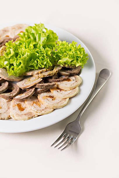 beef roll with dried apricots and salad closeup stock photo