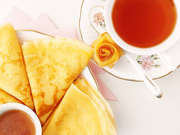 Pancakes with honey and tea stock photo