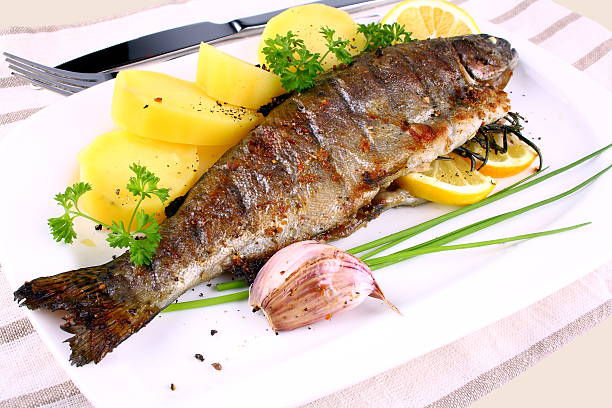 istock Grilled whole trout, potato, lemon and garlic 178175462