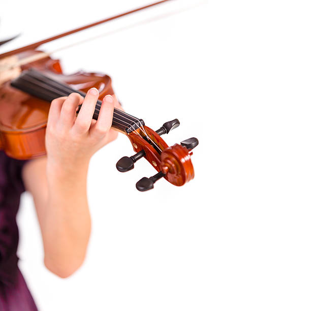 Young girl practicing the violin. stock photo