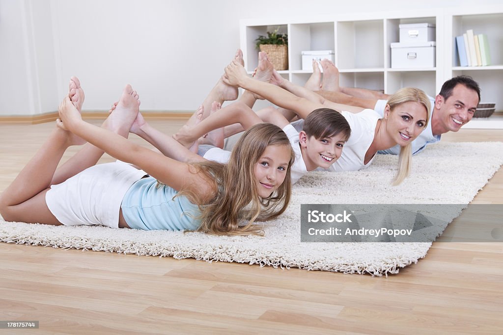 Famiglia facendo esercizi di Stretching - Foto stock royalty-free di Adulto