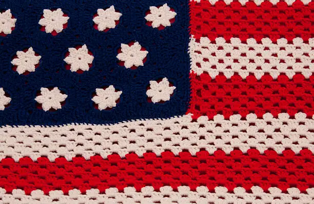 Close up of crocheted American flag blanket in red, white, and blue worsted yarn