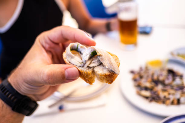 'Boquerones en vinagre' (anchovies in vinegar) on a slice of bread, typical Spanish tapa.