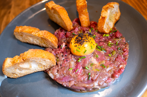 Steak tartar is a classic dish of French cuisine that consists of finely chopped raw beef seasoned with various ingredients to enhance its flavor.