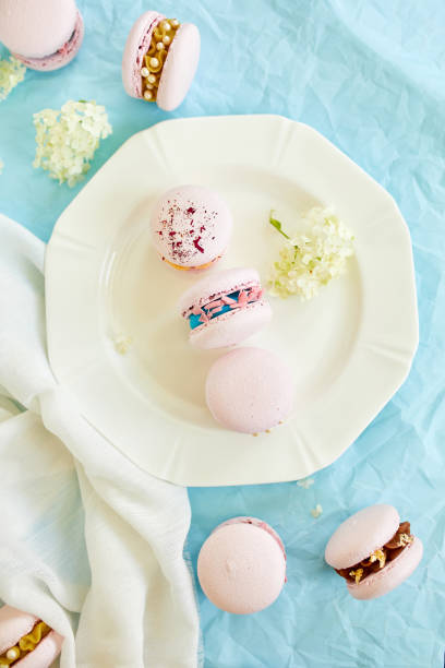 istock Assorted sweet french pink macarons on blue background 1781770105