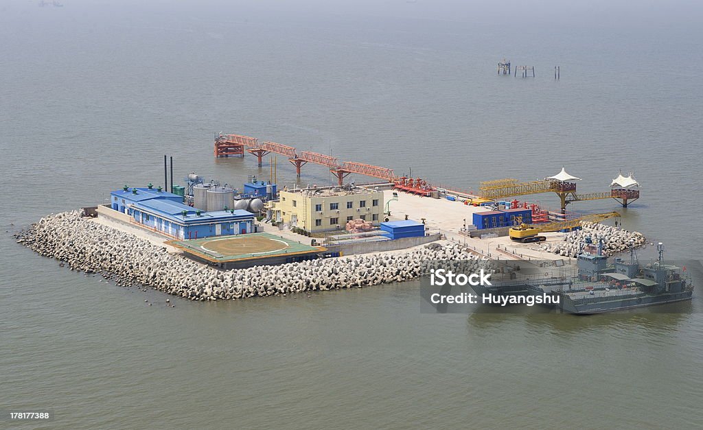 Oil production into the sea from above. Aerial view of deep ocean oil rig production platform Aerial View Stock Photo