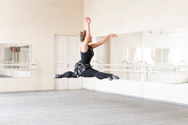 istock female ballerina dancing in the studio, jumping high and fly 1781773924