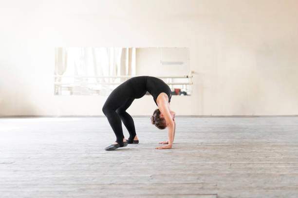 istock a young girl in a ballet class bending backwards 1781774486