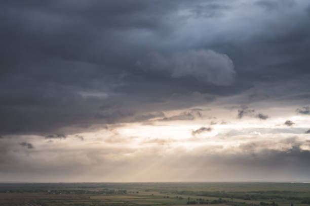 istock Twilight rays in the sky from the sun break through rain clouds in the Asian steppe 1781776769