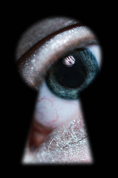istock male eye spying through a keyhole 178178153