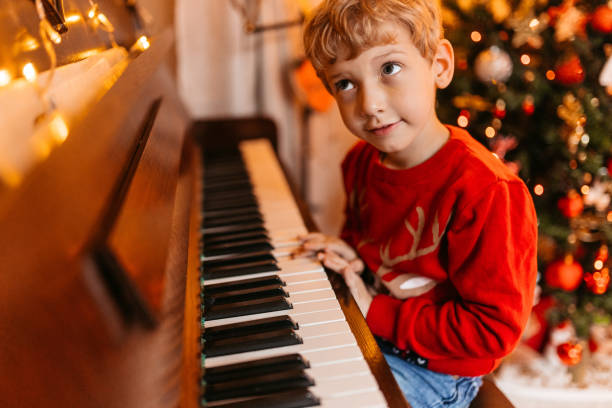 istock Little Boy Playing The Piano For Christmas 1781782945