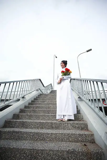 Vietnamese young girl in white traditional dress aodai