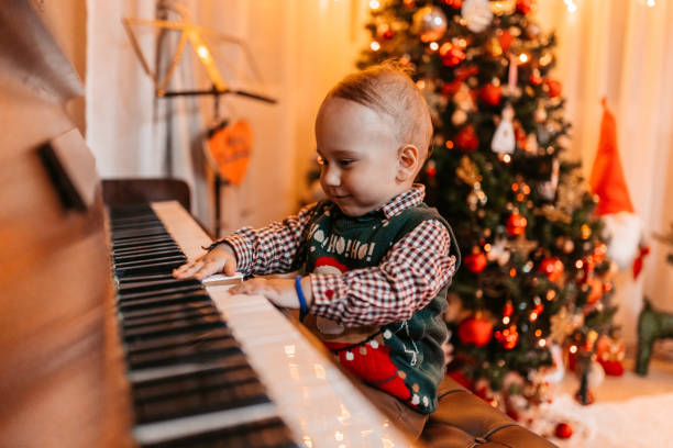 istock Baby Boy Playing The Piano For Christmas 1781797305