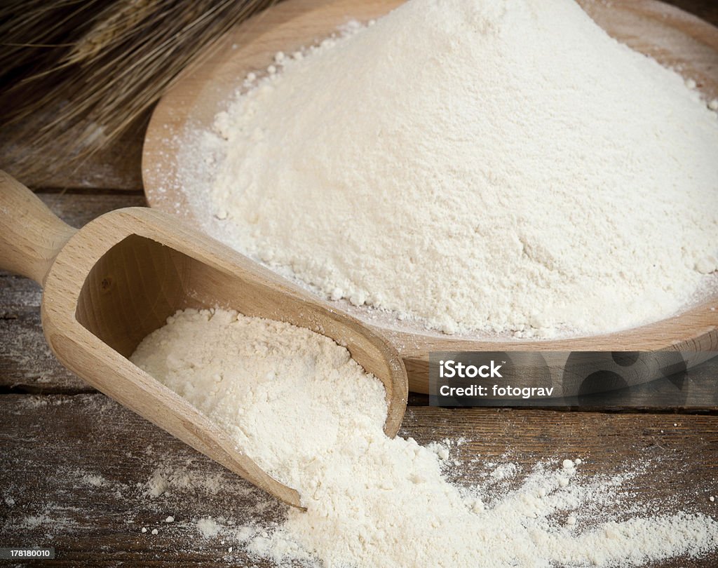 Flour Wooden spoon with white flour for bread and cakes. Bakery Stock Photo