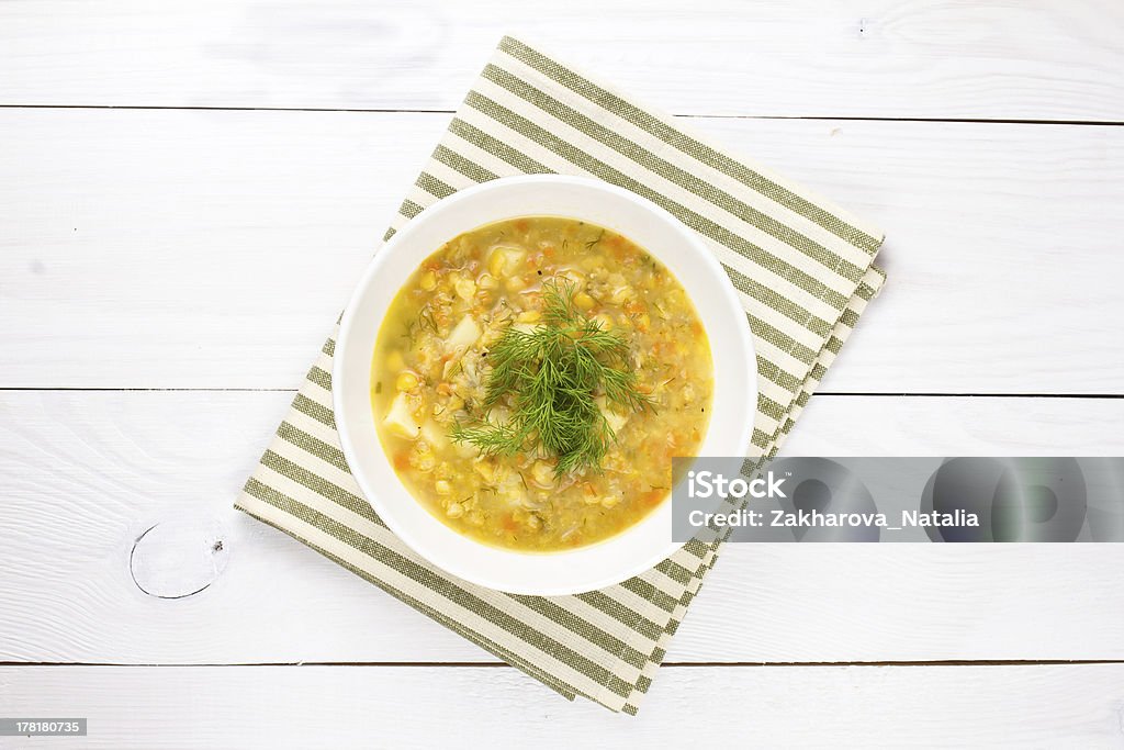 Jaune Soupe de petits pois dans le bol sur fond en bois blanc - Photo de Pois cassé libre de droits