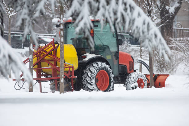 istock Tractor cleaning urban park paths on a cold snowy day. 1781807733