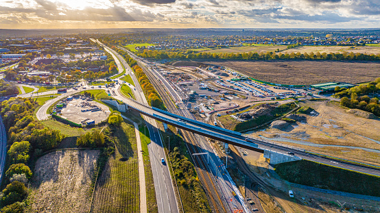 Aerial photo from a drone of newly constructed Boreham Bypass connecting Boreham to Beaulieu. The brand new £14million pound curved 'Generals Lane' bridge spanning over the A12 is hoping to ease congestion on the growing city of Chelmsford in Essex, UK. Construction of the brand new Beaulieu Park Train Station can be seen taking place adjacent to this new bridge.