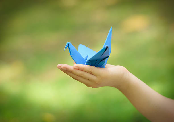 istock paper crane on little girl's hand 178181188