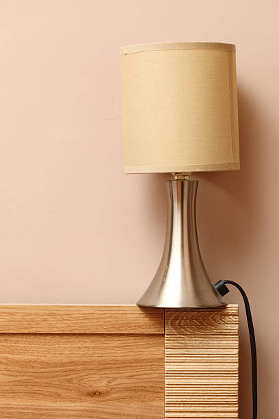 istock lamp on side wooden bed wall background 178181607