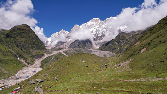 A beautiful view of cloud-covered stunning Himalayan mountain range peaks during a bright day