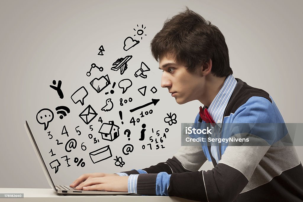 Young man using laptop Young man sitting at table with laptop. Collage drawing Adult Stock Photo