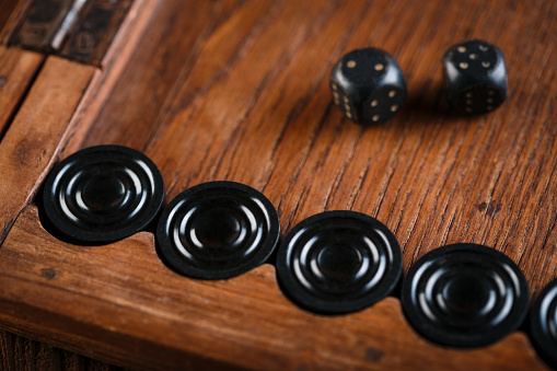 throwing dice in backgammon board game close up, selective focus.