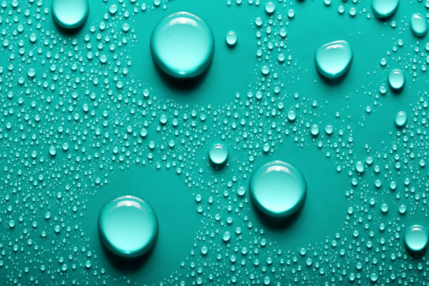 istock Small and large drops of water on a colored background. Abstract liquid sprays 1781852236