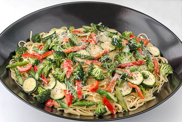 istock Large bowl of pasta primavera on a white background 178185651