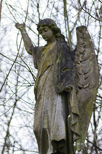 Weeping Angel in dilapidated Graveyard stock photo