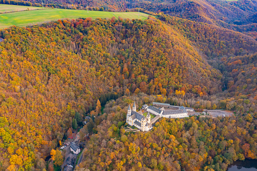 Bird's eye view of the Arnstein monastery near Oberhnhof/Germany on the Lahn in the middle of the autumn forest