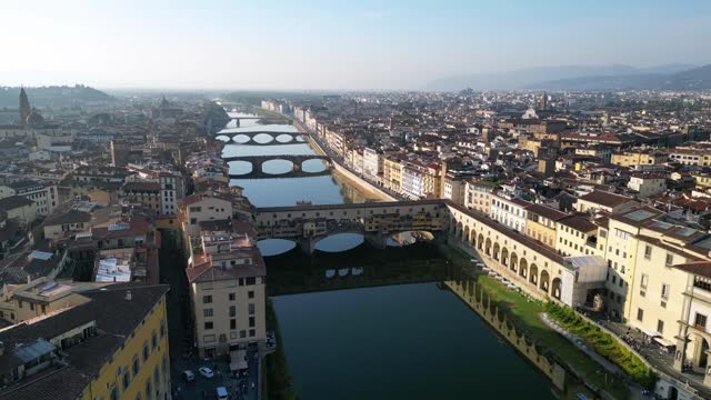 Wonderful aerial top view flight 
Goldsmiths Bridge town Florence river Tuscany Italy. static tripod hovering drone
4k cinematic