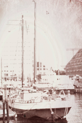 Clipper in Boston harbour at sunrise, Boston, Massachusetts, USA.  The image has been antiqued to make it look old.