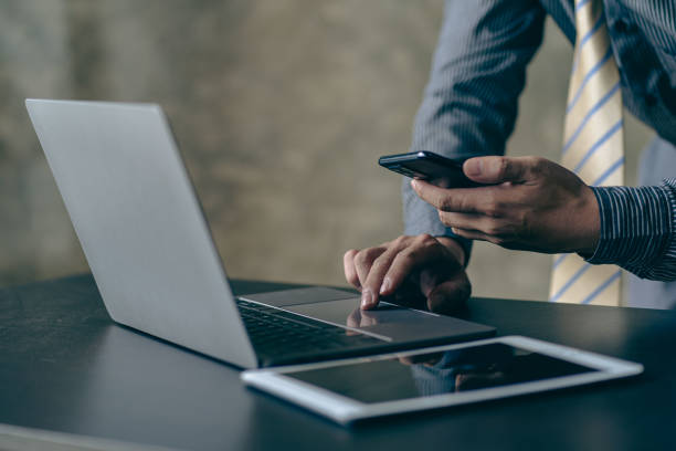 istock Young Asian businessman working with laptop, checking graphs, company budget reports, production control. Operational inspection cost plus price Close-up pictures 1781880912