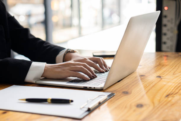 istock Young Asian businessman working with laptop, checking graphs, company budget reports, production control. Operational inspection cost plus price Close-up pictures 1781880955