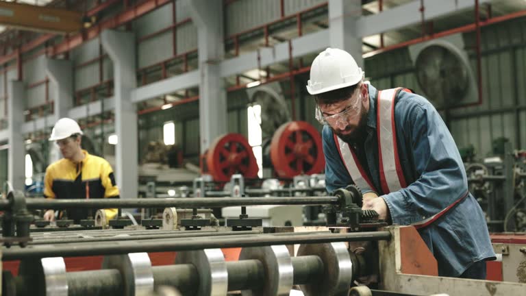 Engineers inspecting machines repairing them profession safety helmet to prevent