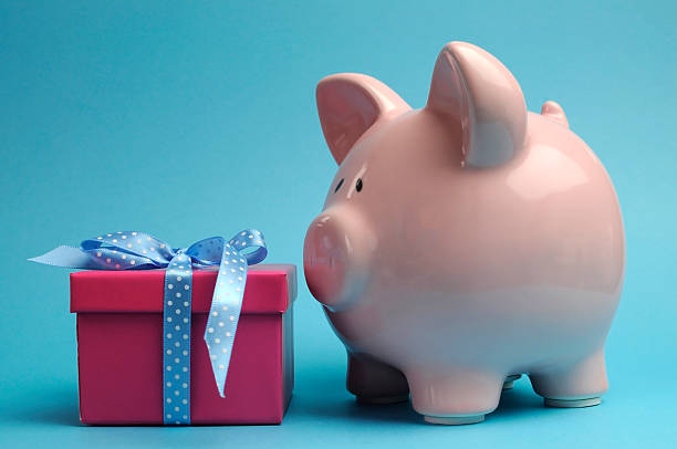 istock Piggy Bank with pretty pink and blue gift. 178189870
