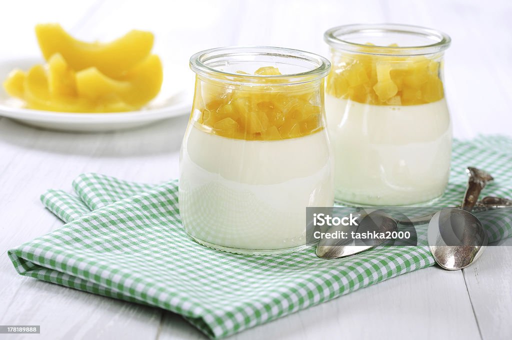 Fruit dessert with mango Fruit dessert with mango in glass jars over white wooden background Appetizer Stock Photo