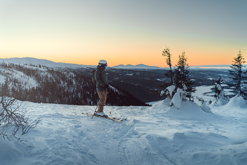 Skiers in the Swedish mountains during a sunset