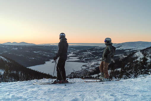 Skiers in the Swedish mountains during a sunset