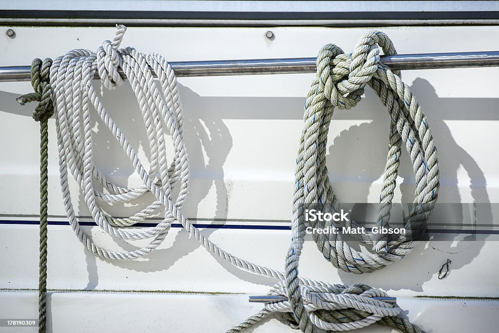 Detail image of ropes and cleats on yacht sailboat Ropes and cleats detail on yacht Boat Deck Stock Photo