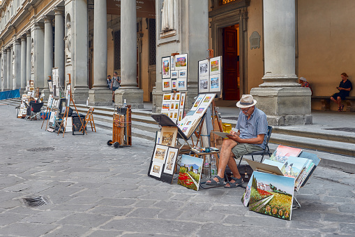 Florence, Italy - 15 July 2023: Artist painters near the Uffizi paint portraits and landscapes