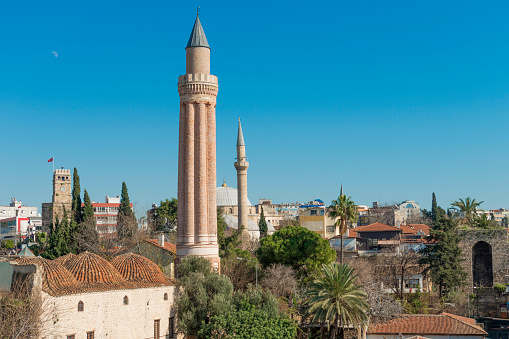 Antalya, Kaleici - 8 February 2014: Buildings and Yivli Minare and Clock Tower, Antalya, Turkey