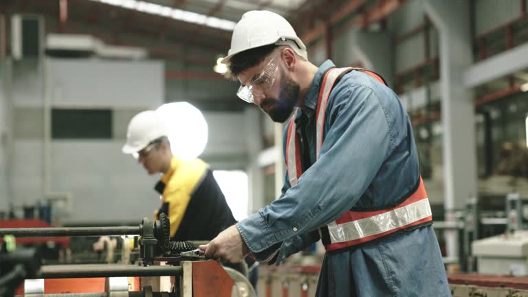 Engineers inspecting machines repairing them profession safety helmet to prevent