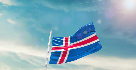 Iceland national flag waving in beautiful sky.