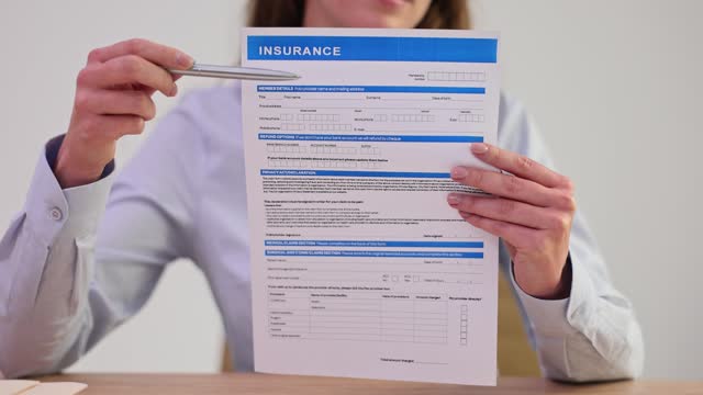 Agent shows offer insurance form for signature closeup