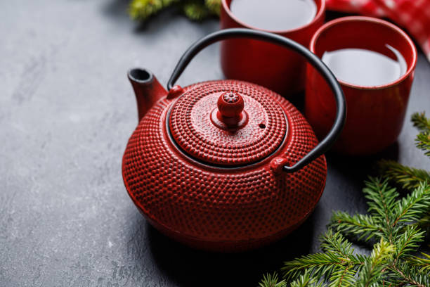 istock Teapot, cup, and fir tree branches create a cozy scene 1781948571