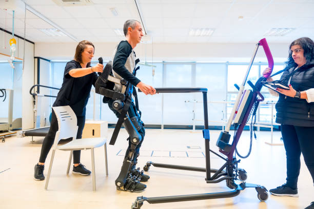 istock Mechanical exoskeleton. Physiotherapy medical assistant lifting disabled person with robotic skeleton to get up. Futuristic rehabilitation, Physiotherapy in a modern hospital 1781959841