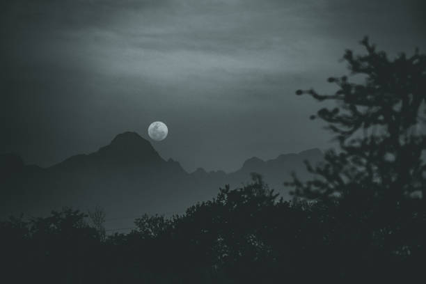 istock Full Supermoon rise over Mountain Moody Black and White 1781961582
